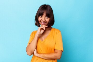 Young mixed race woman isolated on blue background smiling happy and confident, touching chin with hand.