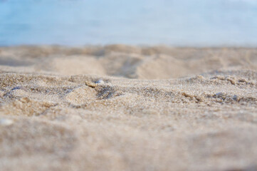 Fototapeta na wymiar Empty beach with light sand with blurred bokeh