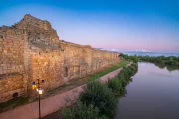 Fototapeta premium Moorish fortification next to the Guadiana river in Merida at sunset 