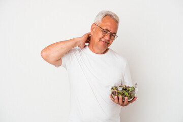 Senior american man eating salad isolated on white background touching back of head, thinking and making a choice.