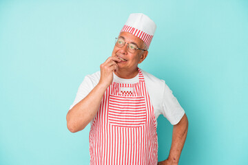 Senior american ice cream man woman holding isolated on blue background relaxed thinking about something looking at a copy space.