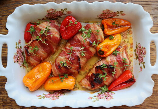 Dinner Background. Grilled Chicken Breast Wrapped In Bacon In Cooking Pan On Wooden Rustic Table . Top View