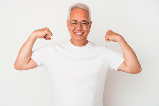 Senior american man isolated on white background showing strength gesture with arms, symbol of feminine power