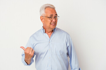 Senior american man isolated on white background shocked pointing with index fingers to a copy space.
