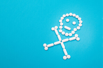 Dangerous Pharmaceutical Products or Unsafe Pills and Tablets - Skull or Death Symbol Made from White Pills Lying on Blue Background