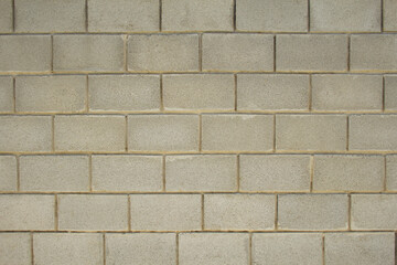 Frontal view of a wall of brown bricks. Imitation brick and wall cladding. Texture; background.