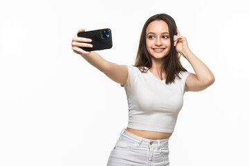 Fototapeta premium Beautiful young woman is making selfie photo with smartphone.