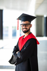 Happy man portrait on her graduation day at University. Education and people.