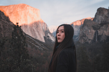 Young woman in Yosemite National Park. Sunset view
