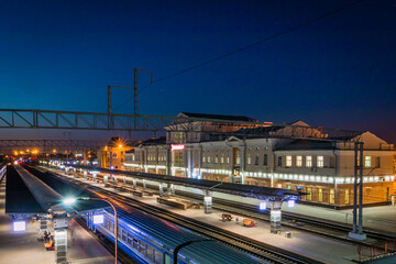the station building and the train on a bright night