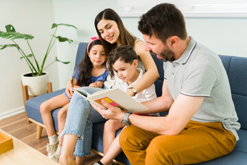 Small kids learning how to read with mom and dad