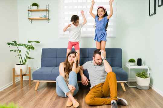 Portrait Of An Exhausted Mom And Dad At Home