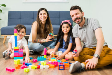 Happy parents enjoying a game with their son and daughter