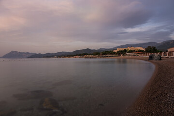 View on rocks and horizon from empty beach with sunshades near rixos hotel tekirova. Mediterranean Sea. Tekirova, Antalya Turkey. May 2021.