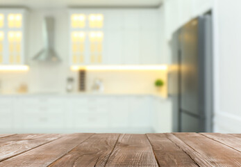 Empty wooden table and blurred view of stylish kitchen interior. Mockup for design