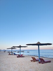 Beach beds umbrellas view vacation 