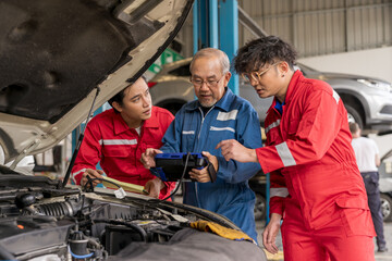 Senior professional mechanic use an obd2 car diagnostics device scanner to interpreting automotive...