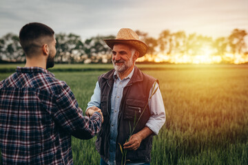 farmers handshake outdoor in field
