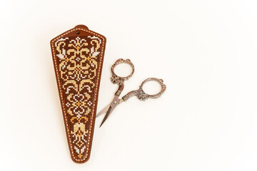 Case for nail scissors. Embroidery with threads on the skin