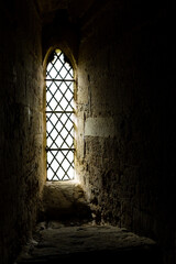 Lead window light shining in a dark church