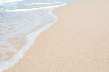 Fototapeta na wymiar Soft sea wave on clean sandy beach