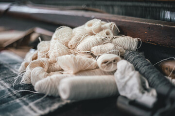 yarn laying on a very old loom