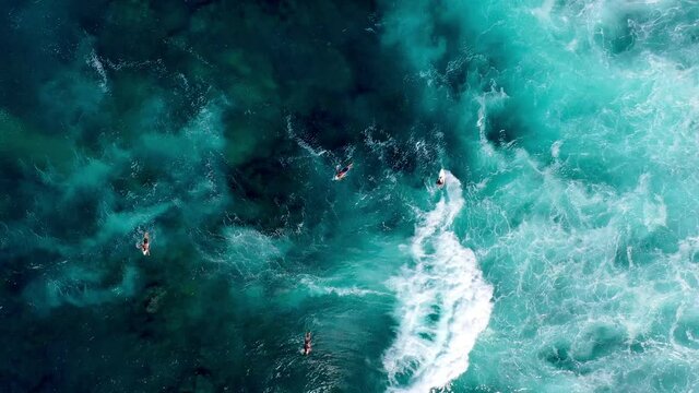 4K drone video tropical travel adventure surfing at a beautiful beach with crystal clear water in paradise