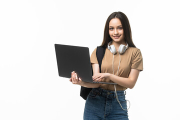 Indoor photo of college student girl isolated on gray background, smiling at camera, pressing...