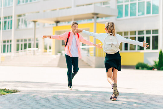 Happy kids are ready for elementary school, Happy classmates Boy and girl greet each other after quarantine, in the backyard