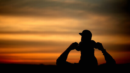 Fototapeta na wymiar A father carries his son on his shoulders in the sunset sky. Happy family together. Father's Day.