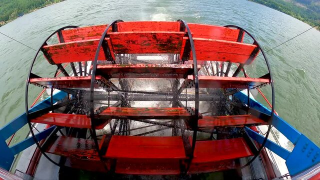 Wide Angle View of Paddle Wheel Spinning on the back of a paddle boat