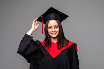 Happy young student with diploma on grey background