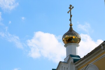 Fototapeta na wymiar Church domes against the blue sky. Domes of the Church with crosses against a clear blue sky on a Sunny day.