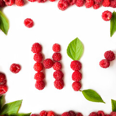 Raspberries on a white background with inscription, isolated objects, green leaves, red summer berries