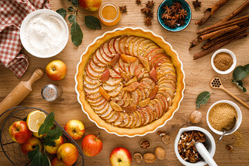 Thanksgiving autumn apple pie with fresh fruits and walnuts on wooden table, top view - obrazy, fototapety, plakaty