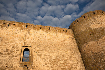 stone wall of the fortress or castle against the blue sky