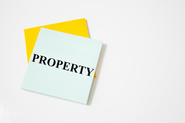property text written on a white notepad with colored pencils and a yellow background. word