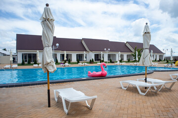 Flamingo pool float in swimming pool blue water background. Flamingo inflatable float for kids and adult.