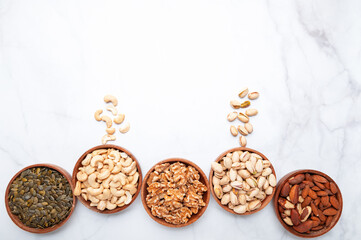 Fototapeta na wymiar Different kind of nuts in wooden bowls