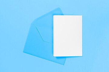 Blank white card with blue envelope isolated on blue background. Template or mock-up. Banner with copy space.