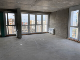 New apartment, new building without finishing and repair, with free planning and walls made of concrete, bricks and gas silicate blocks without partitions and with large panoramic windows