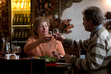Middle-aged couple enjoying wine in the restaurant