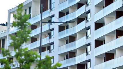 Eco architecture. Green tree and apartment building. The harmony of nature and modernity.