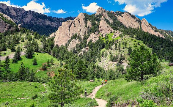 Hikers approach the Rocky Mountain foothills near Boulder, Colorado