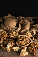 walnuts on a rustic table with a black backdrop