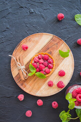 A healthy tasty dessert of cheese raspberry tart. Creative atmospheric decoration