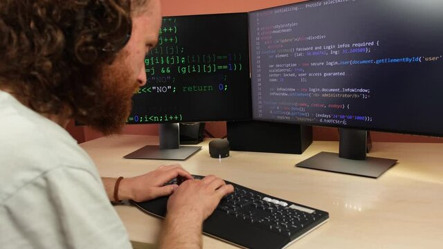 Programmer Writes Code on Computer