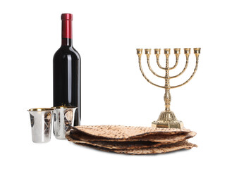 Tasty matzos, wine and menorah on white background. Passover (Pesach) celebration