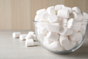 Delicious puffy marshmallows on wooden table, closeup