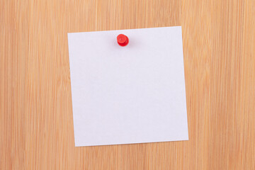 White Sticky Note with Copyspace Pinned to the Wooden Message Board. To Do List Reminder in Office. Blank Memo Sticker at Work - Template. Empty Checklist - Mockup